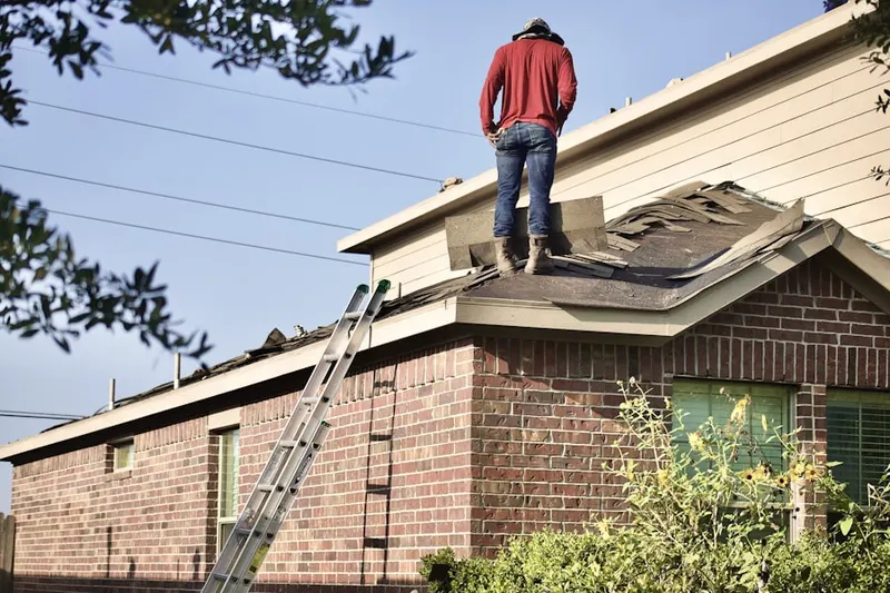 Professional roofer working on a residential roof in Sandersville